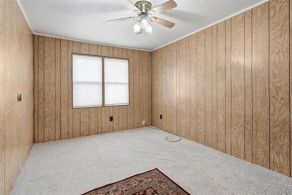 Wood-paneled bedroom before staging